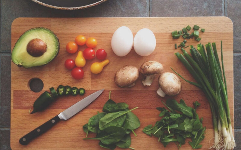 variety of vegetables and two hard boiled eggs representing healthy brain foods for seniors and their memory